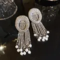 Luxury rhinestone tassel earrings with sparkling zircons and elegant pearl drop details. - Silver