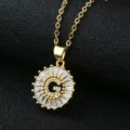 Close-up detail of the gold-plated letter G pendant necklace with sparkling cubic zirconia. - Gold Letter G