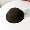 Close-up detail of the classic black woolen flat top hat showcasing the fine felt texture. - M (56-58cm) / Coffee