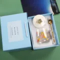 Detailed view of the cute heat-resistant glass coffee mug set with gift box and gold spoon. - Yellow Dog Mug with Lid & Spoon in Blue Gift Box