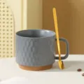 Detail shot of modern grey ceramic coffee mug with textured pattern and gold spoon. - Dark Grey + Spoon