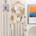 Detailed macro view of the elegant beige floral print and soft fabric of the summer shawl - Style 6