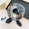 Close-up detail of a vintage paisley patchwork cotton linen square scarf head wrap neckerchief. - Caramel Color Block Paisley