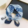 Close-up detail of the retro blue paisley bandana scarf showing delicate patchwork and pattern. - Blue Color Block Paisley