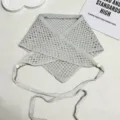 Primer plano de un pañuelo triangular de punto calado gris con detalles de cuentas. - 84x30cm / Gris claro