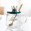 Tasse à café en verre transparent avec couvercle couronne verte et cuillère dorée, design élégant. - Couvercle Couronne + Cuillère / Vert