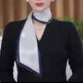 Detailed view of the elegant long silk scarf with rhinestone detail and navy border. - Blue Border White