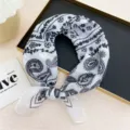 Detailed shot of black and white paisley print scarf, elegant neck accessory and cute hair band. - White Dot Paisley