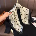 Detailed shot of elegant silk square scarf with classic polka dot pattern and stylish black border. - RY-32