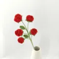 Detail view of handmade crochet red rose bouquet in a white vase, craft flower gift - Version B / Red