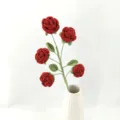 Handcrafted crochet multi-head red rose bouquet with green leaves in a white ceramic vase detail. - Version C / Red