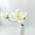 Close-up detail of hand-crocheted white bellflower in a ceramic vase for home decor. - White