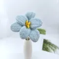 Handcrafted crochet blue flower with yellow stamen in a ceramic vase detail view. - Blue Series A
