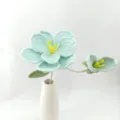 Handmade crochet blue flower detail, delicate knitted floral decor piece in white vase. - Crystal Blue