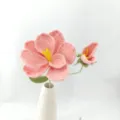 Detailed shot of handmade crochet pink flower bouquet with ceramic vase, perfect for home decor. - Coral Pink
