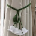 Handcrafted crochet curtain tieback featuring elegant lily of the valley design for home decor. - Lily of the Valley Style
