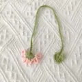 Handmade crochet flower bookmark detail showing delicate pink bloom and green stem. - Pink Flower Bookmark / Pink