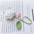 Handcrafted crochet white rose bookmark and bag charm made with soft yarn for gifts. - White