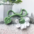 Handmade crochet flower bookmark with green leaf stem and cute heart design, perfect gift. - White