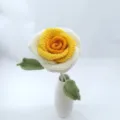 Handmade crochet rose flower with white and yellow gradient petals and green leaves in vase. - Gradient Deep Yellow