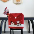 Christmas chair cover featuring cute Santa and snowman cartoon patterns for holiday dining room decor. - Printed Chair Cover