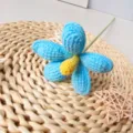 Handmade crochet blue flower with yellow center and green stem for chic home decor & fresh floral. - Sky Blue Finished Product