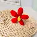 Handmade crochet red flower with yellow center, ideal for home decor and floral arrangements. - Bright Red Finished Product
