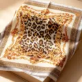 Detailed view of a luxury French vintage baroque leopard print square silk scarf inside a box. - HX-5