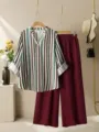 Detailed view of the chic striped V-neck blouse and maroon pleated wide-leg pants set. - S / Top And Bottom / Burgundy