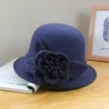 Close-up view of the elegant dark blue wool felt dome hat featuring exquisite side floral decor. - Solid Color Peony - Navy Blue / Adjustable