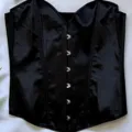 Black satin corset top with front metal busk clasps, shaping and bustier style for women. - Black