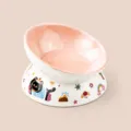 Ceramic elevated cat bowl with cute black cat pattern, tilted design for neck protection. - Slanted Bowl / Pink