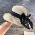 Summer women's straw hat with black bow and vintage mesh veil, elegant Hepburn style sun hat. - M (56-58cm) / Beige