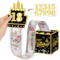 Set de caja de dinero de cumpleaños con adorno de torta negro y dorado y rollo sorpresa. - Negro