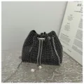 Close-up detail of a shiny black rhinestone drawstring bucket bag with elegant pearl charms - Silver