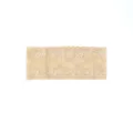 Close-up detail of beige lace stretch headband featuring delicate floral bow pattern. - Off White