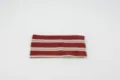 Detailed view of the red and white striped elastic knitted headband, ideal for sports. - Red White