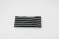 Close-up detail showing the black and grey striped texture of the elastic knitted headband. - Gray Black