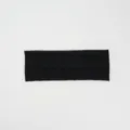 Detailed view of the black knitted headband showing the textured diamond cable pattern. - Black