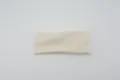 Detailed close-up view of a solid color wide elastic athletic headband soft fabric. - Off White