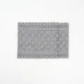 Detailed view of grey lace elastic hairband, showing delicate floral pattern texture close up. - Gray