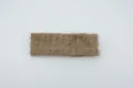 Beige pleated elastic knit headband detail, showing soft textured fabric and vertical stripes. - Camel
