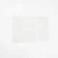 Detailed close-up of white lace wide elastic headband featuring delicate floral pattern. - White
