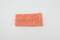 Orange elastic knitted headband detail, featuring vertical ruffles and soft texture. - Orange