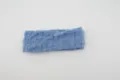 Blue stretchy knit fabric headband with vertical ruffles and frilly edge design for daily wear. - Blue