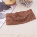 Brown knitted elastic headband hair accessory detail shot, cozy texture and daily stylish wear. - Amber