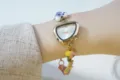 Detail shot of irregular triangle dial women quartz watch with colorful ceramic enamel bead bracelet. - Gold