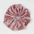 Close-up detail view of the soft pink velvet hair scrunchie, showing plush fabric texture. - Deep Pink