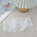 White elastic lace headband detail shot, delicate hollow hair accessory for elegant women. - White