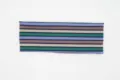 Close-up detail shot of a vintage knitted striped headband with high elasticity and wide design. - Purple and Green Stripe